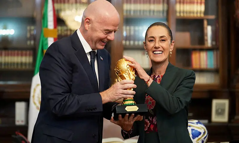 Mexican President Claudia Sheinbaum and FIFA's Gianni Infantino smile with the World Cup trophy