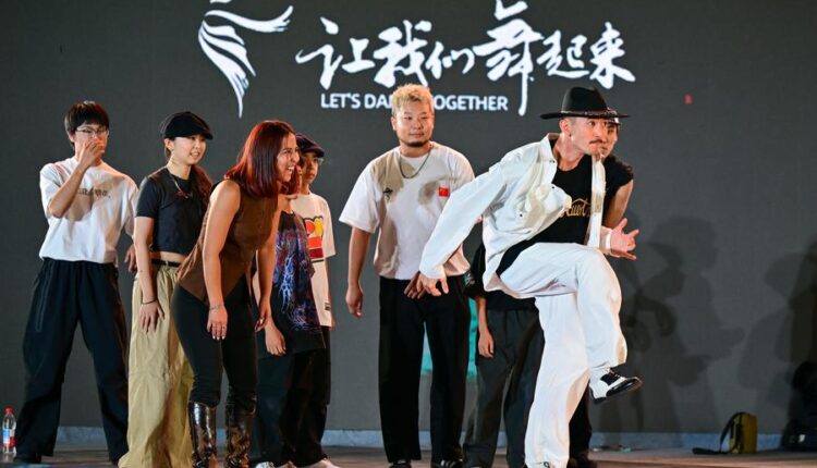 International dancers perform at the Xinjiang Dance Festival 2025, showcasing global cultures in Urumqi, China.