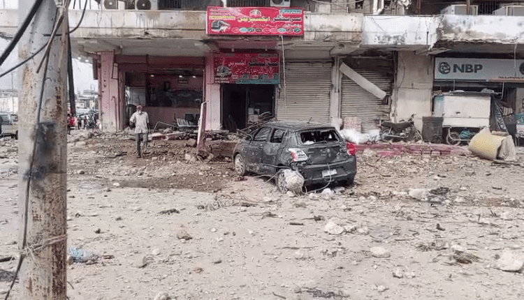 Firefighters respond to a large warehouse fire with thick black smoke in Karachi.