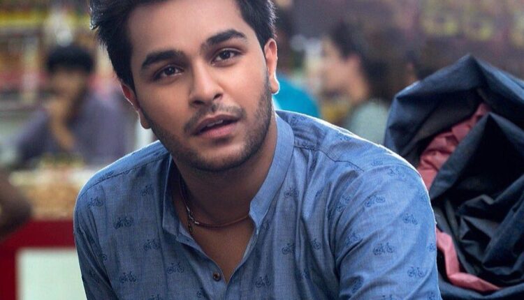 Singer Asim Azhar looks seriously at the camera with a concerned expression.