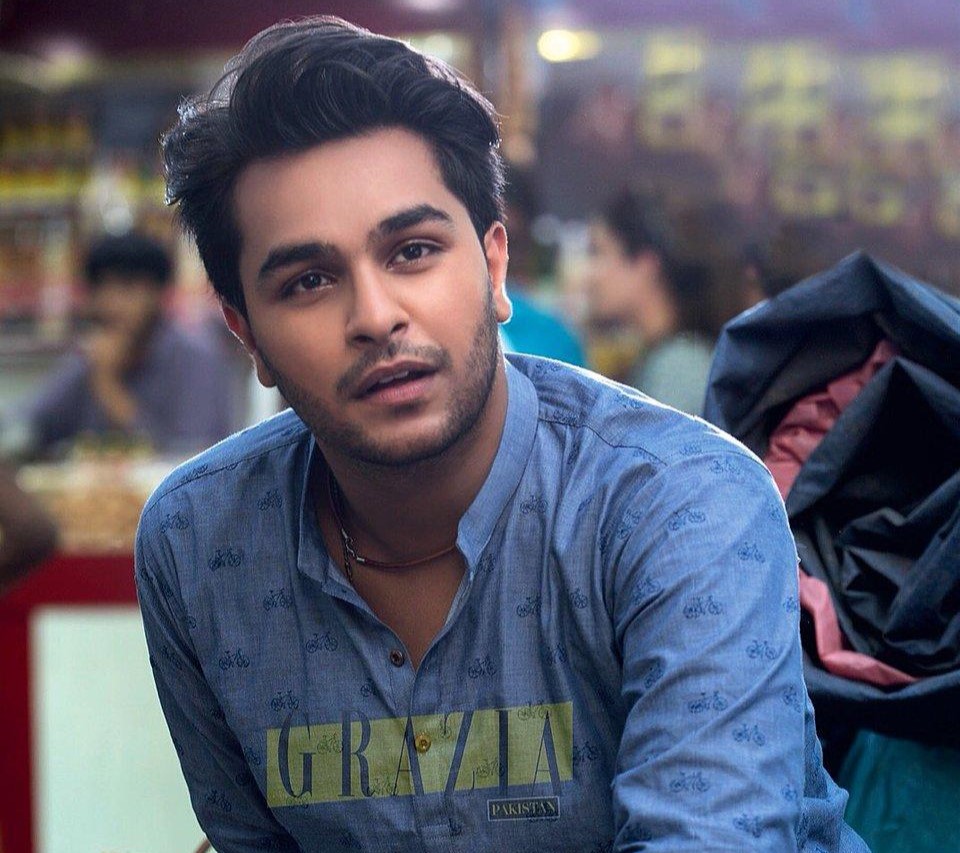 Singer Asim Azhar looks seriously at the camera with a concerned expression.