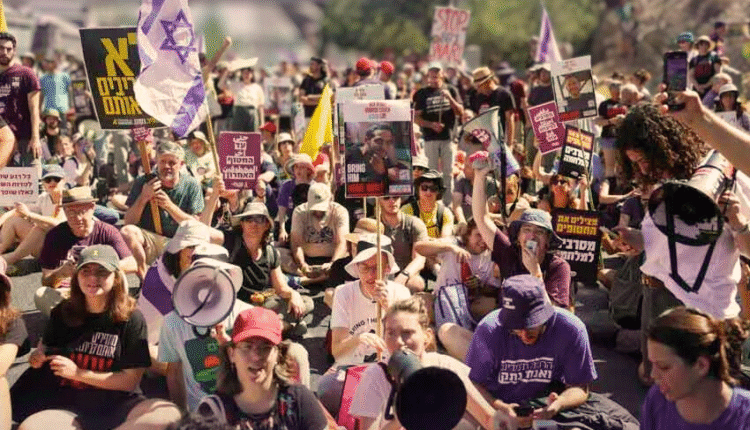 Israeli protesters in Tel Aviv holding flags and pictures of hostages during nationwide demonstrations demanding peace and an end to the Gaza war.