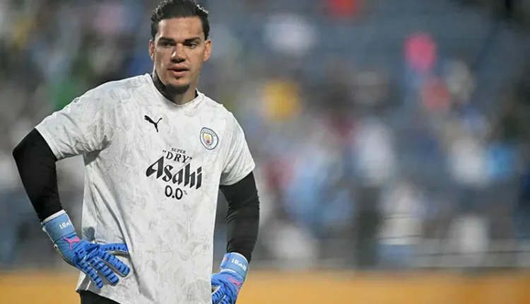 Ederson holding a Manchester City jersey after announcing transfer to Fenerbahce football club.