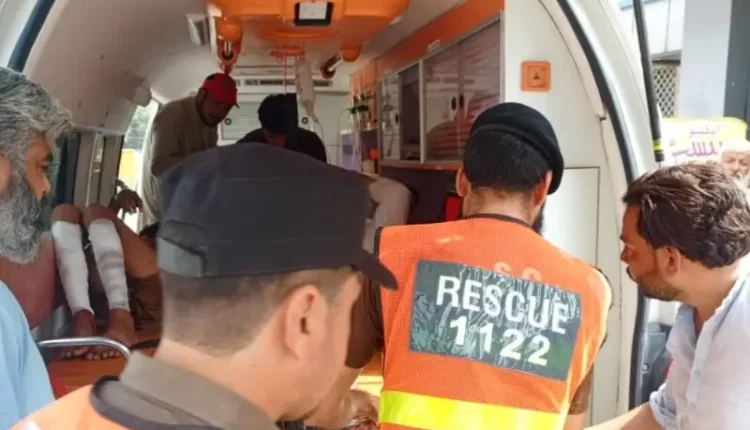 Rescue workers at the scene of a grenade explosion outside a scrap metal shop in Mardan.