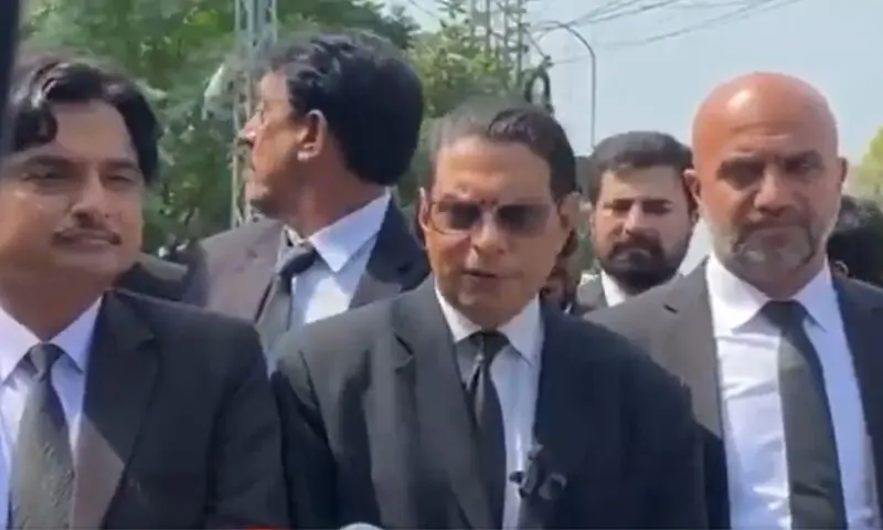 Imran Khan's lawyers are seen in a Rawalpindi anti-terrorism court, with a laptop displaying a disrupted video call on screen.