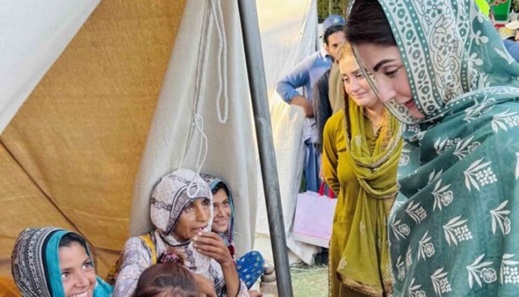Punjab Chief Minister Maryam Nawaz Sharif helping an elderly woman during flood relief efforts in Zahir Pir.