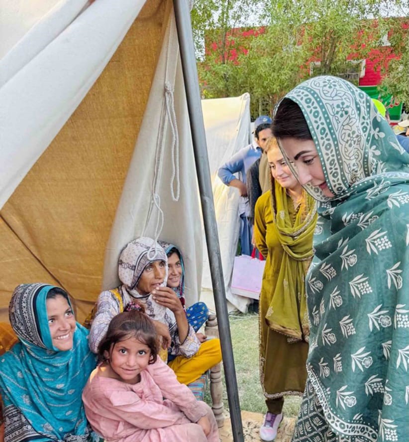 Punjab Chief Minister Maryam Nawaz Sharif helping an elderly woman during flood relief efforts in Zahir Pir.