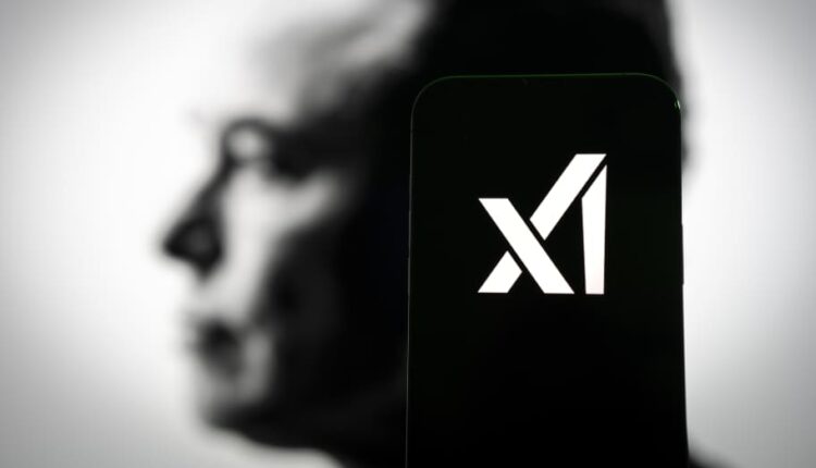 Elon Musk looking thoughtful at a tech conference.