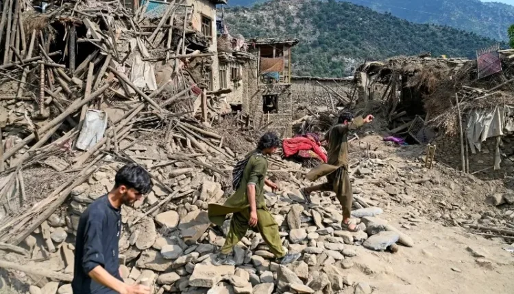 A rescue worker searches through debris after a powerful earthquake in Afghanistan’s eastern mountains.